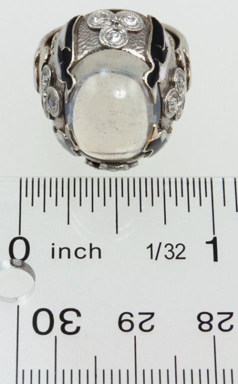 This is one crazy ring!!  It is 14k white gold with a hammered finish.  There is a dreamy center moonstone, and four enamel black and white penguins!  And on each side of the shank are 3 diamonds, to represent some ice!
* This ring is currently a