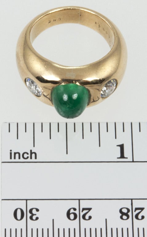 18k Yellow gold ring with a center 2 carat cabochon emerald and two side old European cut diamonds each weighing .33 cts each. They are set into the gold but look to be H-I color and SI clarity.  I love how rounded it is, there are no sharp edges on