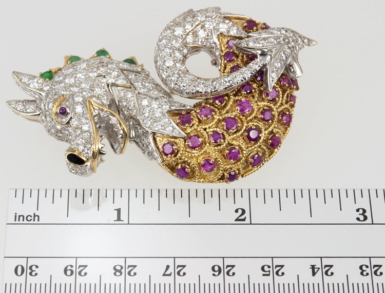 Is this a friendly dragon?  I think so! He's Italian after all.
Wearing this on a jacket or shawl will get everyone's attention because he has so much dazzle! He's paved with 8 carats of beautiful diamonds, his belly has 1.50 carats of rubies, and