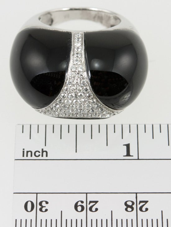 This 18 karat white gold dome ring features black jade set en cabochon with 1.20cts of diamonds in an abstract design- so chic! Size 6.25 and easily altered.