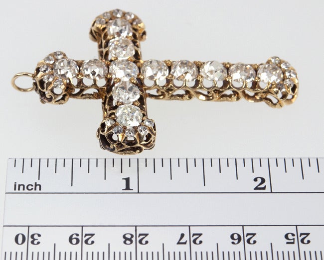 This cross shines from across the room!  10 carats of Old Mine Cut Diamonds are set into this amazing 18 karat yellow gold Victorian cross, H-I VS-SI.  It has a brooch attachment and a hinged bale so it can be worn either as a brooch or a pendant.