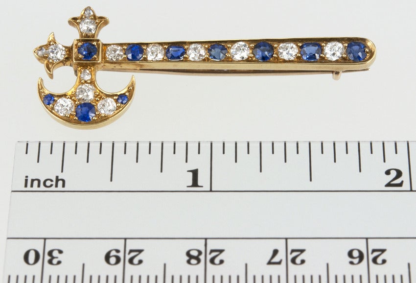 You need a hatchet brooch.  No really.  This fine quality hatchet is 18 karat yellow gold set with 1 carat of Old European cut diamonds and 1 carat in lovely blue sapphires.  In the fitted box marked 