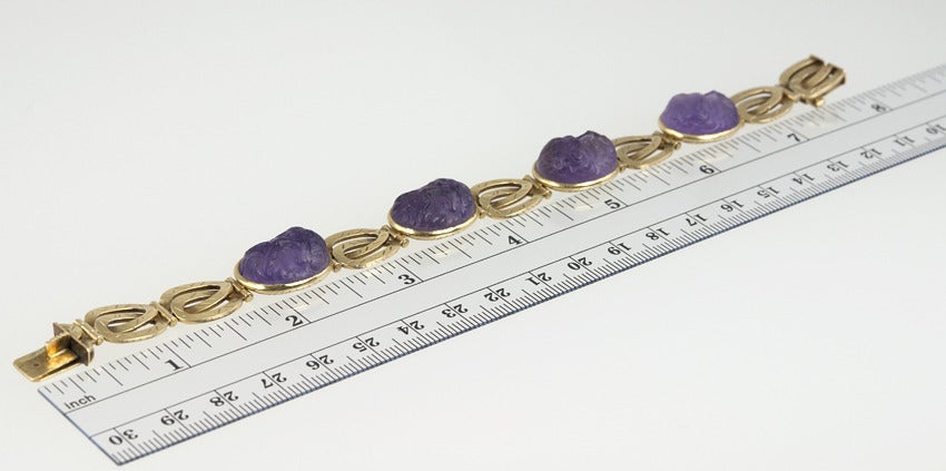 4 carved males faces in Amethyst grace this Victorian bracelet.  The backs of the bezels are beautifully engraved.  14 karat yellow gold.