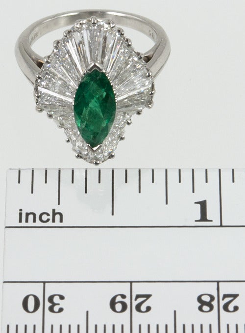 Oscar Heyman emerald and diamond baguette ballerina ring in platinum. A fine marquise cut emerald graces long undulating baguettes. A center 0.81 carat emerald with 24 diamonds which total 2.47carats of high quality white diamonds. Oscar Heyman