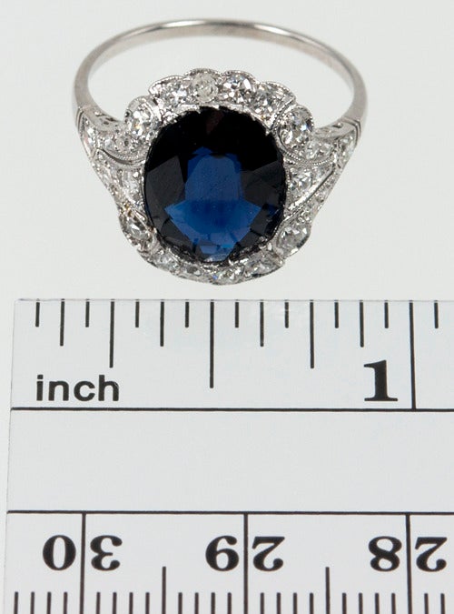 This sapphire ring is fit for a princess!  The low profile makes it easy to wear.  The sapphire is a dark blue and approximately 3.50 carats, with 0.50 carats of diamonds set around it in the platinum mounting.  

Size 7 and easily altered.
