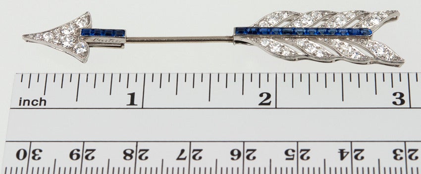Cartier Arrow Jabot set with diamonds and sapphires.  Set in platinum it is signed and numbered.  So CHIC!