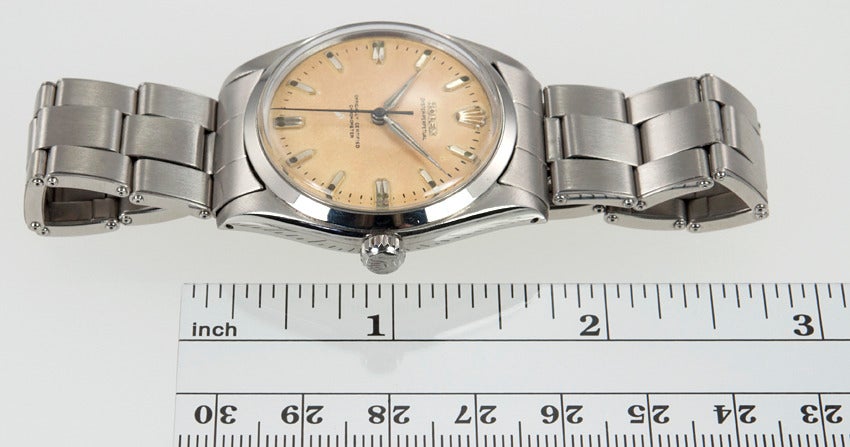Rolex stainless steel Oyster Perpetual wristwatch, Ref. 6564, circa 1958. This automatic watch has a 25 jewel movement and features an original cream dial with batons. The case is 34mm and looks great on men and women alike.
This watch is includes