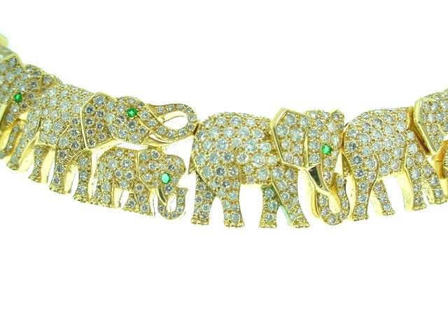 This is a breathtaking designer necklace by Cartier.  The adorable elephant necklace features five pavé diamond large elephants and two baby elephants with emerald eyes. <br />
<br />
The necklace also has another thirteen large elephants along