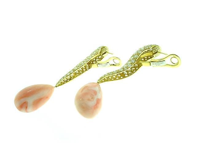 This is a stunning pair of designer earrings  by  de GRISOGONO is 18K yellow gold, featuring approximately  12cts of fine diamonds. . .with teardrop shaped angel skin coral drops.
These fabulous earrings retail for over $70,000 and are brand new
