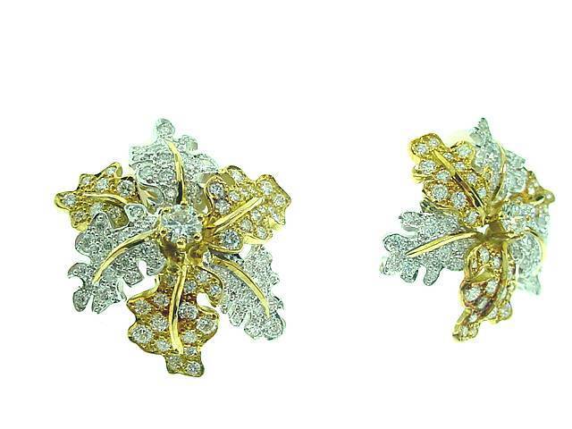 This is a magnificent pair of oak leaf diamond earrings. .. in 18k white and yellow gold. . .Each earring features a brilliant-cut diamond in the center. . . leaves are set with 134 pave' set  brilliant cut diamonds. . .These earrings come with