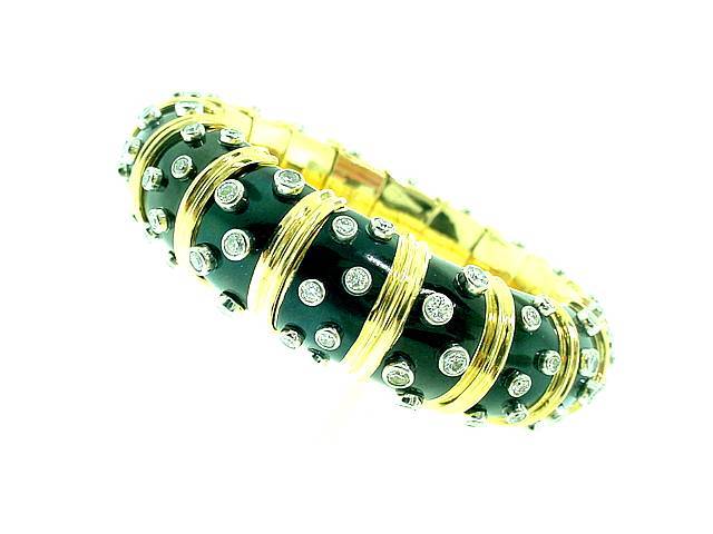 This is an incredibly gorgeous wide black paollone enamel bracelet by Jean Schlumberger for Tiffany & Co. The bracelet is 18k yellow gold and features approximately 7.20cts of fine diamonds bezel-set in platinum.
Bracelet measures 6 7/8