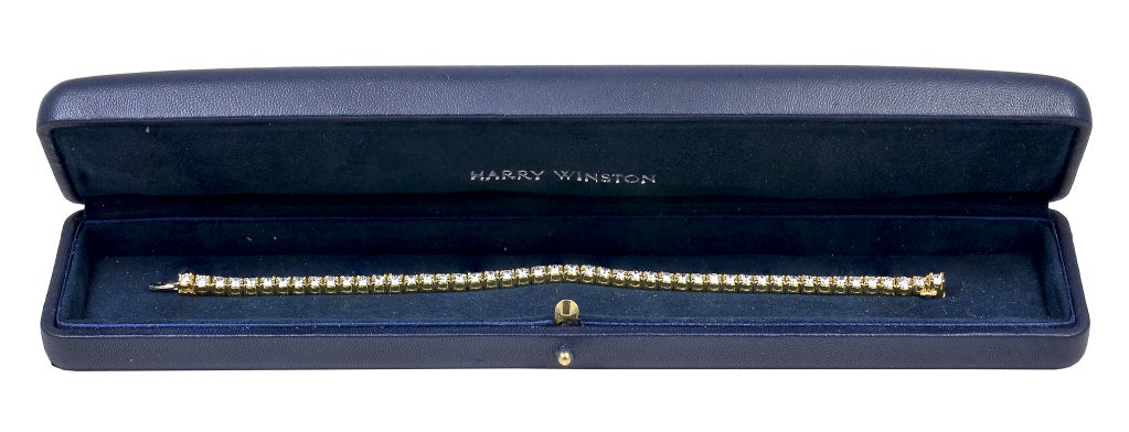 Harry Winston 18K yellow gold 3 prong mounting tennis bracelet.  48 round brilliant cut diamonds totaling 4.70 cts.  It is 6.75
