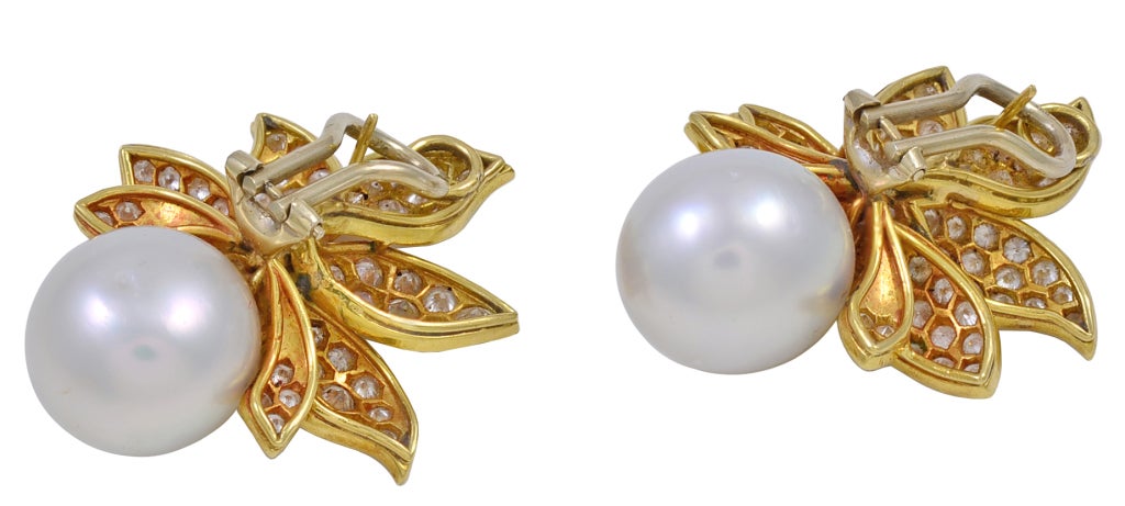Gorgeous 18K yellow gold, diamond and white South Sea pearl earrings.  Earrings contain approximately 4 cts total weight.  South Sea pearls are approximately 15mm. They are pierced with an omega back clip.  Posts are easily removed if