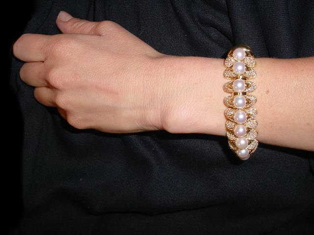 This is a truly phenomenal designer bracelet by BULGARI. . .featuring cultured pearls and fine white diamonds. . . .from the Celtaura  Collection. . .signed
and comes in original  BULGARI presentation box.  
Bracelet originally sold for $75,000