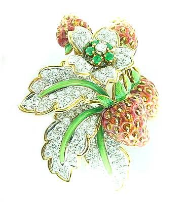 This is a captivating enamel MOBA  pin. . .strawberries  featuring  red  enamel  with green  enamel  leaves. . .brilliant-cut  diamonds total  approximately  3cts. . ..with emerald and diamond cluster in the center  of  the  blossom. . .signed  Moba