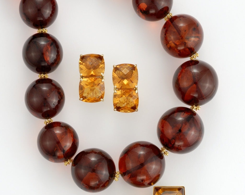Strand of graduated 13mm-28mm red amber bead Necklace with granulated 18 karat gold beads. Signed Sorab & Roshi.