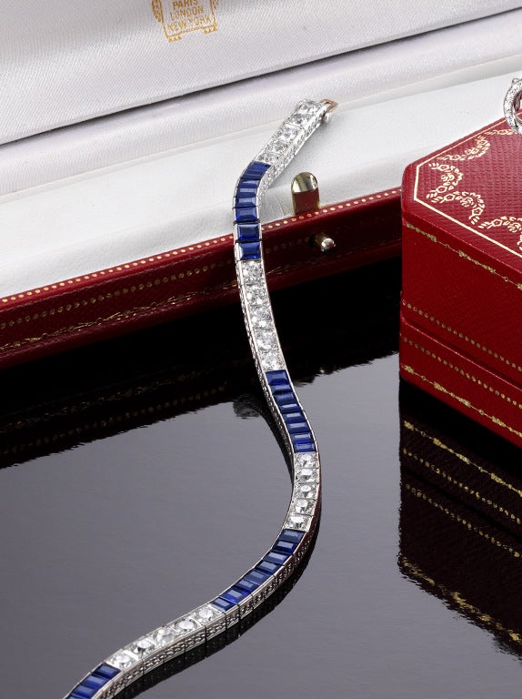 Platinum,diamond and sapphire straightline bracelet by Cartier.
