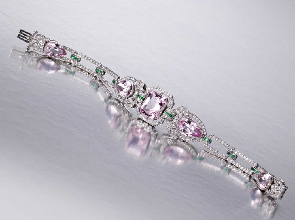Appoximately 30 cts. of fine marganite (pink beryl) in five pear and emerald-cuts accented throughout with European-cut diamonds and calibre-cut emeralds.