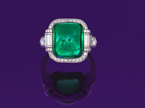 This platinum ring centers an exactly 10.69 ct. emerald which is accompanied by a report confirming it is Colombian in origin; this center stone is accented with fine fancy cut diamonds