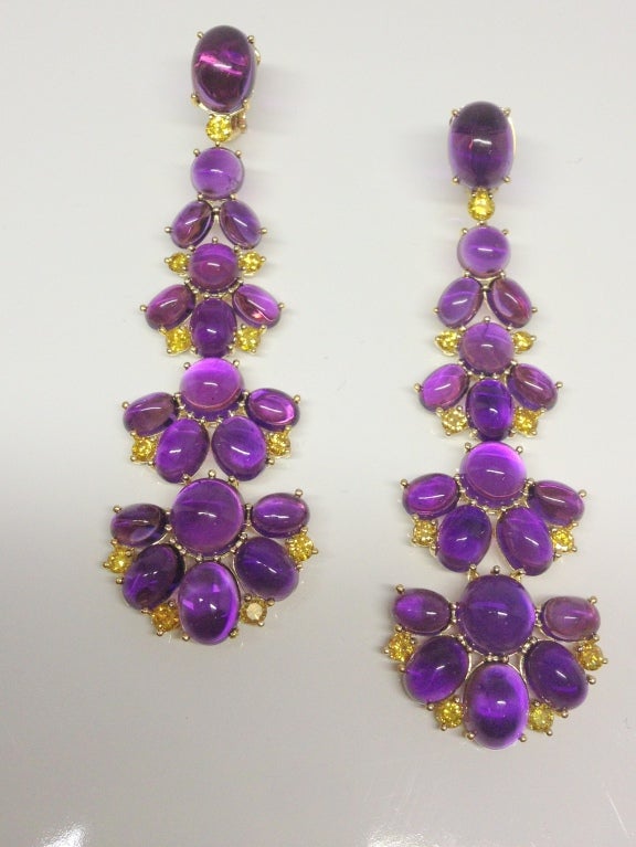 18K yellow gold, cabachon amethyst (33 Carats) and natural, fancy, vivid yellow diamond earrings (2.2 Carats). These earrings are 3 inches long with 22 fine fancy yellow diamonds and 38 bright purple amethysts.