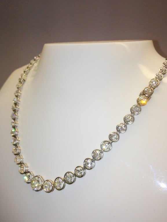 This necklace (which converts to a bracelet) has 63 round European-cut diamonds,ranging in size from .08 to 1.50 cts., prong set in platinum, with an approximate weight of 20.11 cts.  The stones range in color from approximately G-J, and the clarity