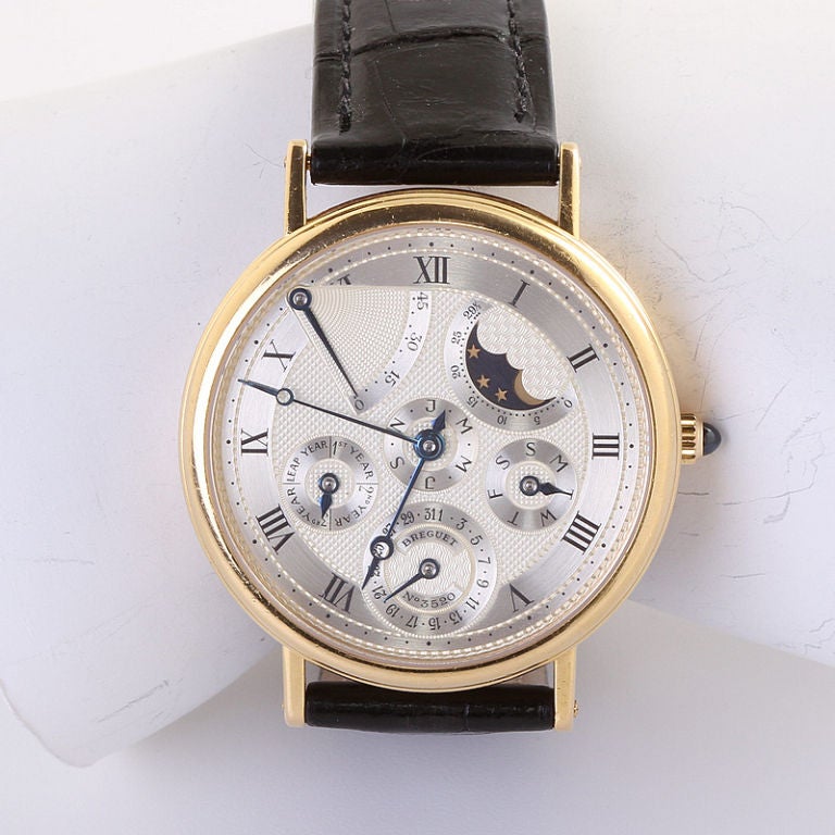 Breguet 18k yellow gold perpetual calendar wristwatch with moon phase and power reserve from the Classique Complications Collection with Alligator Strap. In great condition this watch has a transparent case back so the movement is visible.
Original