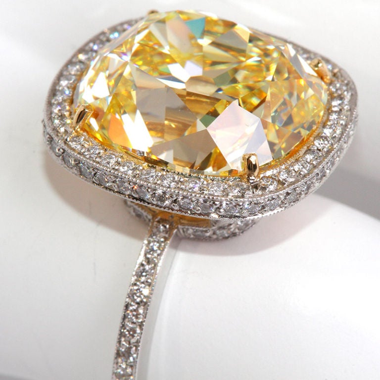 This rare jaw-dropper 10.85 carat natural fancy intense yellow diamond is also internally flawless. The shape is referred to as old miner or the original cushion cut.<br />
The light and delicate micro pave in platinum setting is a wonderfully