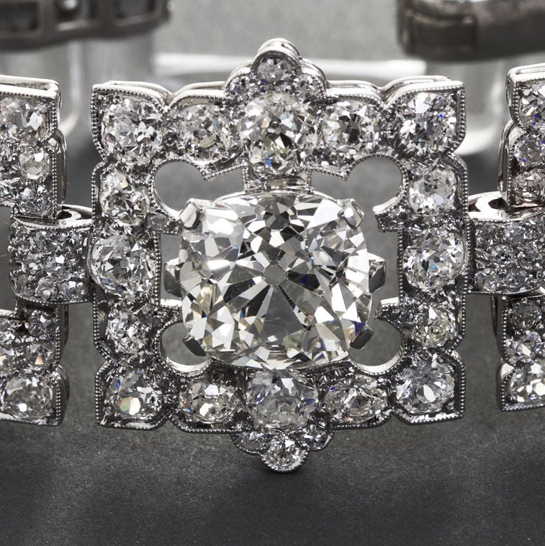 One old cushion cut diamond in platinum center panel is graced by two identical panels with old euro cut diamonds linked to three rectangular rock crystal open links, mounted in platinum. Absolutely breathtaking deco design, craftsmanship, and