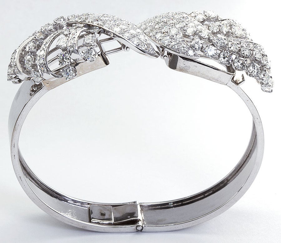 A unique diamond in white gold bangle with two removable twin diamond  brooches. 

No. 2862

