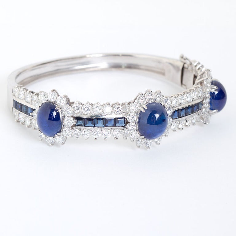 Fine diamonds and magnificent cabochon sapphire set 18k white gold bangle. Center sapphire cabochons are ~8cts set between square cut sapphires of ~2cts and fine round brilliant diamonds of ~6.50cts.

Dealer ref No. 3517