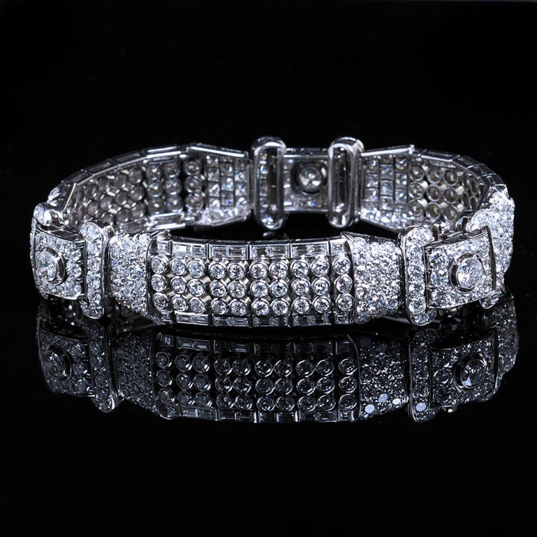 A very pretty and unique diamond in platinum bracelet from the Art Deco period.  The bracelet contains over 20 carats of collection quality diamonds including three larger old European cut center diamonds of  approx. 0.35 ct each. The internal