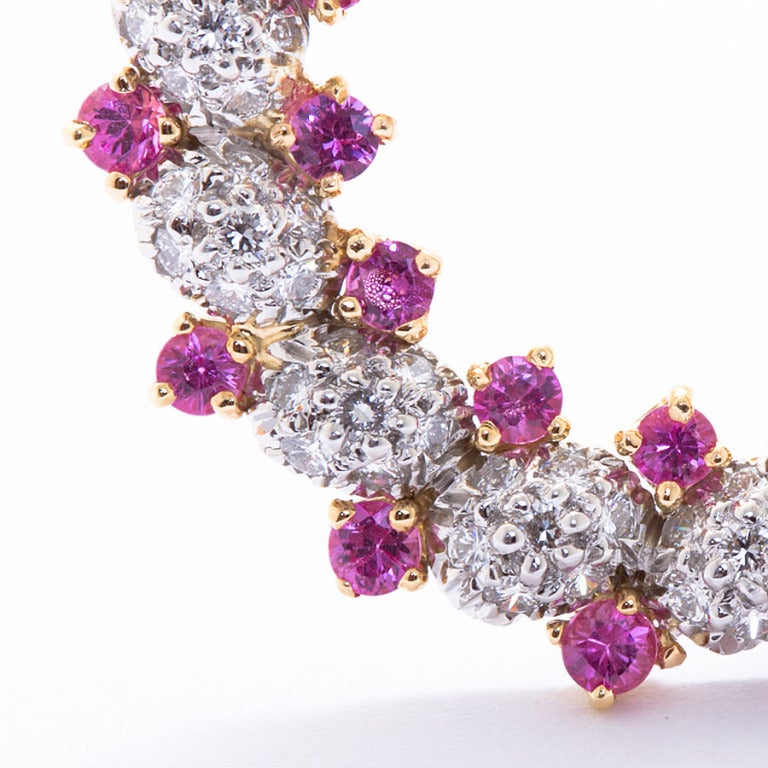 Oscar heyman pink sapphire and diamond circle brooch ~3.00 carats sapphire and ~2.50cts diamonds in platinum and 18 karat gold.
Signed OH and numbered.
1-3/8