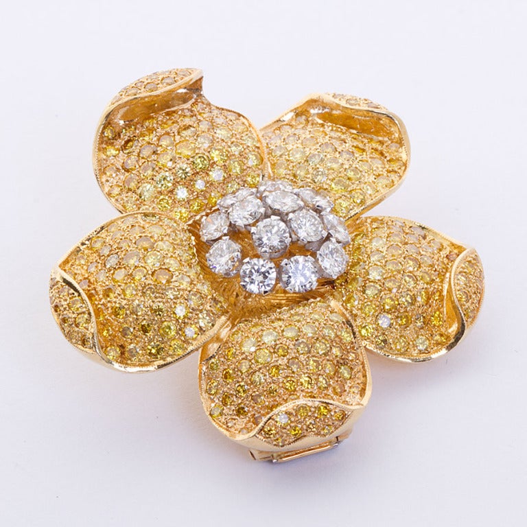 Very finely crafted 18k gold brooch inlaid with round brilliant natural canary color and white diamonds. 
Measures: 4.77cm (1-7/8 inches) wide.
Unidentified Hallmark (see photos)
Yellow diamonds: approx. 11.00 ctw
White diamonds: approx. 2.50