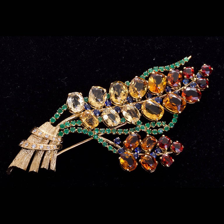 A fabulous 18k gold and colored stone bouquet brooch. 4.5