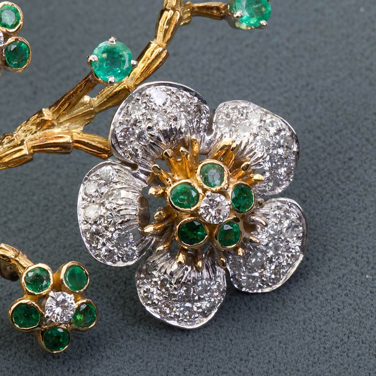 Diamond and emerald vintage flowers brooch. Diamond content is approximately 4.10 carats, with an additional 1.40 carats of emeralds.
Measures 1.75 x 2.75 inches.

Dealer ref. 4847