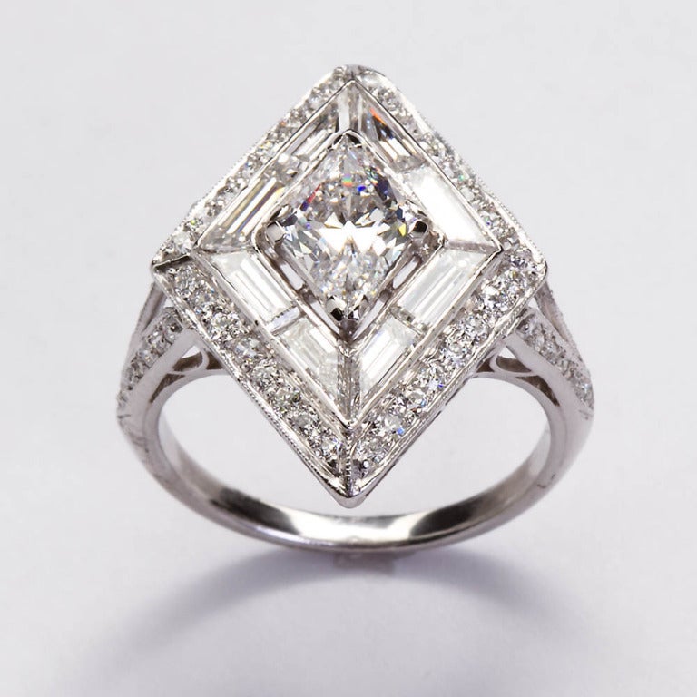 A remarkable platinum diamond ring from the Art Deco period. The styling on this ring and the center stone are very rare and exceptionally endearing. Center diamond is a Lozenge shape brilliant cut diamond with a GIA report grading it as a 1.10