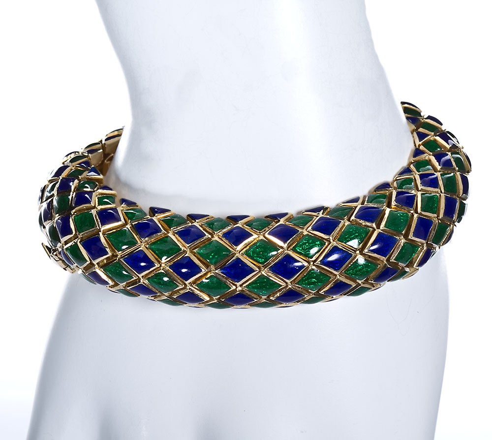 A classic Webb design. This one is in translucent Egyptian blue and emerald green enamel over 18k yellow gold in a diagonal checkered design. This is a hefty piece weighing almost 130 grams but wears comfortably and fits all wrist sizes. It's
