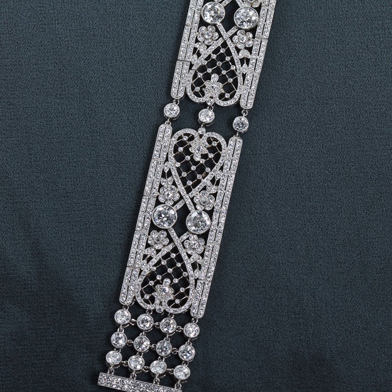 An exceptional diamond in platinum choker style necklace from the Art deco period. Features very delicate and precise millegraining and lattice work. Meticulous craftsmanship is such that at each hinged section the designs remarkably line up.