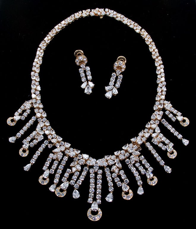 The necklace designed as pairs of brilliant-cut diamonds alternating with pear-shaped stones, embellished at the front with fringes of brilliant-cut diamonds terminating with pear-shaped and stylized crescent motifs, mounted in 18k yellow gold,