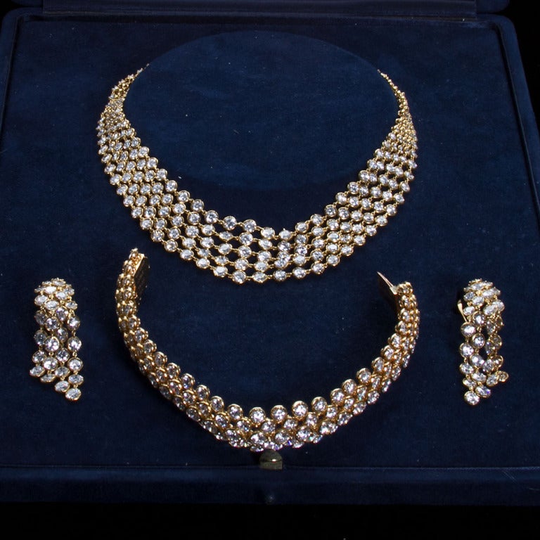 A circa 1960 diamond in 18k yellow gold suit of necklace, bracelet and earrings. Contains approximately 100 carats of high collection quality diamonds.
Highly flexible necklace designed of five rows of graduated brilliant-cut diamonds, a bracelet