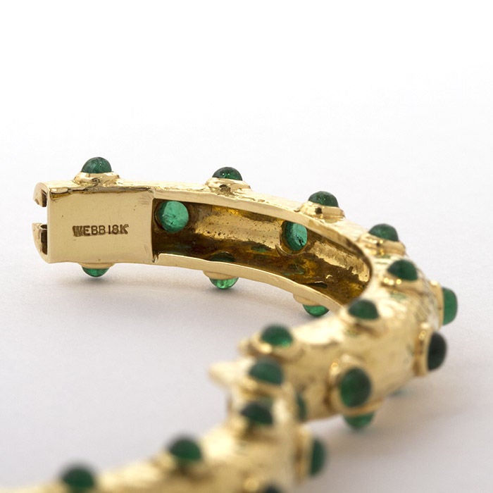 David Webb hammered 18k gold hinged bangle with emerald cabochon polka dot design. 2-1/8