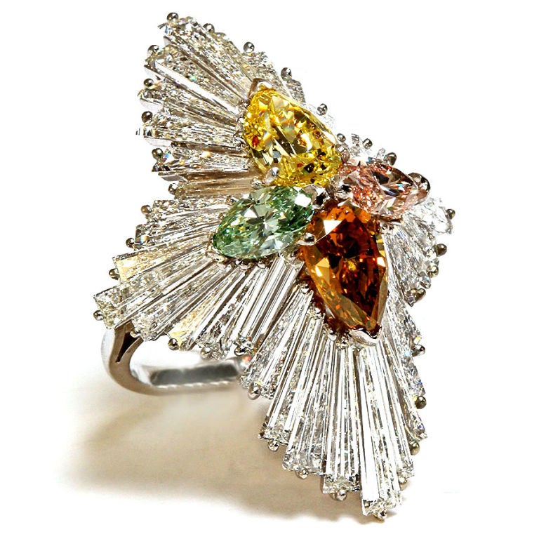 One of a kind ballerina ring with 36 magnificent long tapered baguettes clustering around four fancy colored diamonds:<br />
Fancy intense yellow, Fancy intense blueish green, Fancy intense dark brownish orange, and Fancy intense pink.<br />
All
