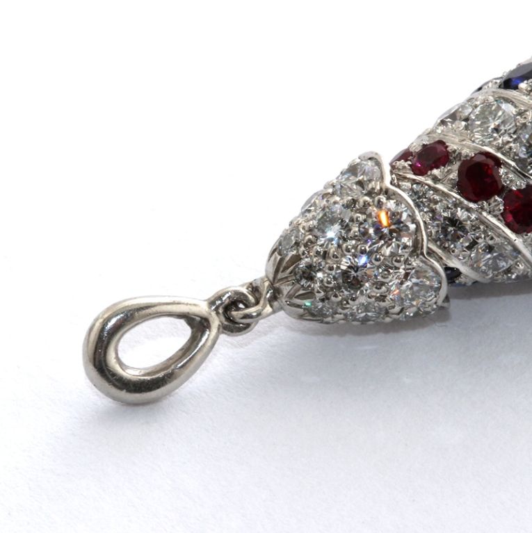 Oscar Heyman diamond, ruby and sapphire teardrop pendant with swirl design. 
Weighs 11.1 gram, 2.8 cm tall, 1.1 cm wide

No.  1442