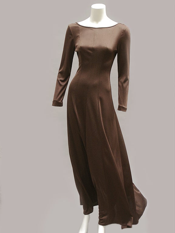 Jean Varon designed exquisite clothes with class--less sexy siren at the disco than elegant lady in a beautiful dress at a party. This sweep of chocolate brown jersey covers the arms and decolletage but leaves the back beautifully exposed. It's both