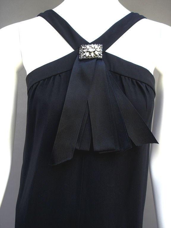 Elegant Little Black Crepe Cocktail Dress Adorned With Satin Ribbons And A Rhinestone Detail . . . Vee-Shaped Straps Go Over The Shoulders . . . Lined In Black Silk . . . Metal Back Zipper . . . So Pretty And Feminine . . . The BLACK SATIN Ribbon