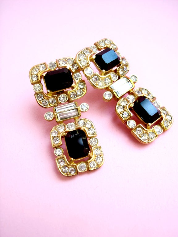 Gorgeous oversized earrings covered with rhinestones. Hinged centers. Post backs. Signed Givenchy.<br />
<br />
We love how the top segment is placed horizontally, while the lower is vertical--it's a chic design . . . Good heavy, weighty