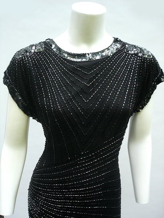 Super Gorgeous Black Silk bead dress by Oleg Cassini. Dress is super liqiud- like a slip- sleeves are capped style- no shoulder pads these hang with a drapped softness. ( our mannequin  can stand a bit broad in the shoulders  .

Love the almost