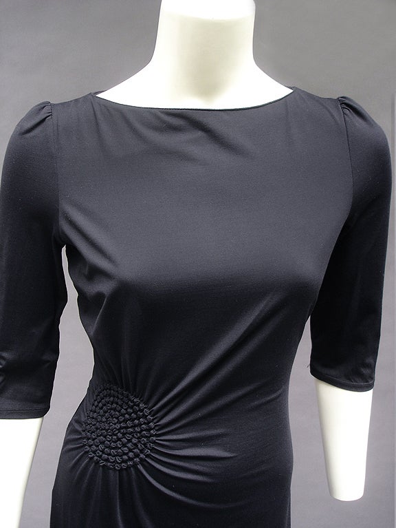 LBD in soft and smooth soft jersey lycra. Underneath is a tube dress of the finest mesh--like gossamer. Sunburst feature at right side of gathered waist. Slight a-line skirt. Three-quarter sleeves. Boat neck. Simple and chic for day or night.