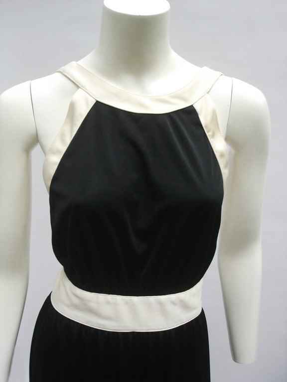 Love Love Love this Classic Bill Tice dress... in Black and Ivory- with such a faux Chanel appeal- column style - simple and elegant...super light weight -liquid nylon fabric... button closure at the back... looking as if never worn .

Size 4/6