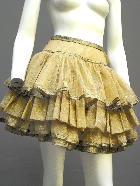 One of the best things we've ever had, and it gives us such a thrill!<br />
<br />
Gianni Versace Couture golden tulle mini skirt with the tiniest mesh ... All netting with no lining ... Pale gold, banded with deeper gold/bronze at the edge of the